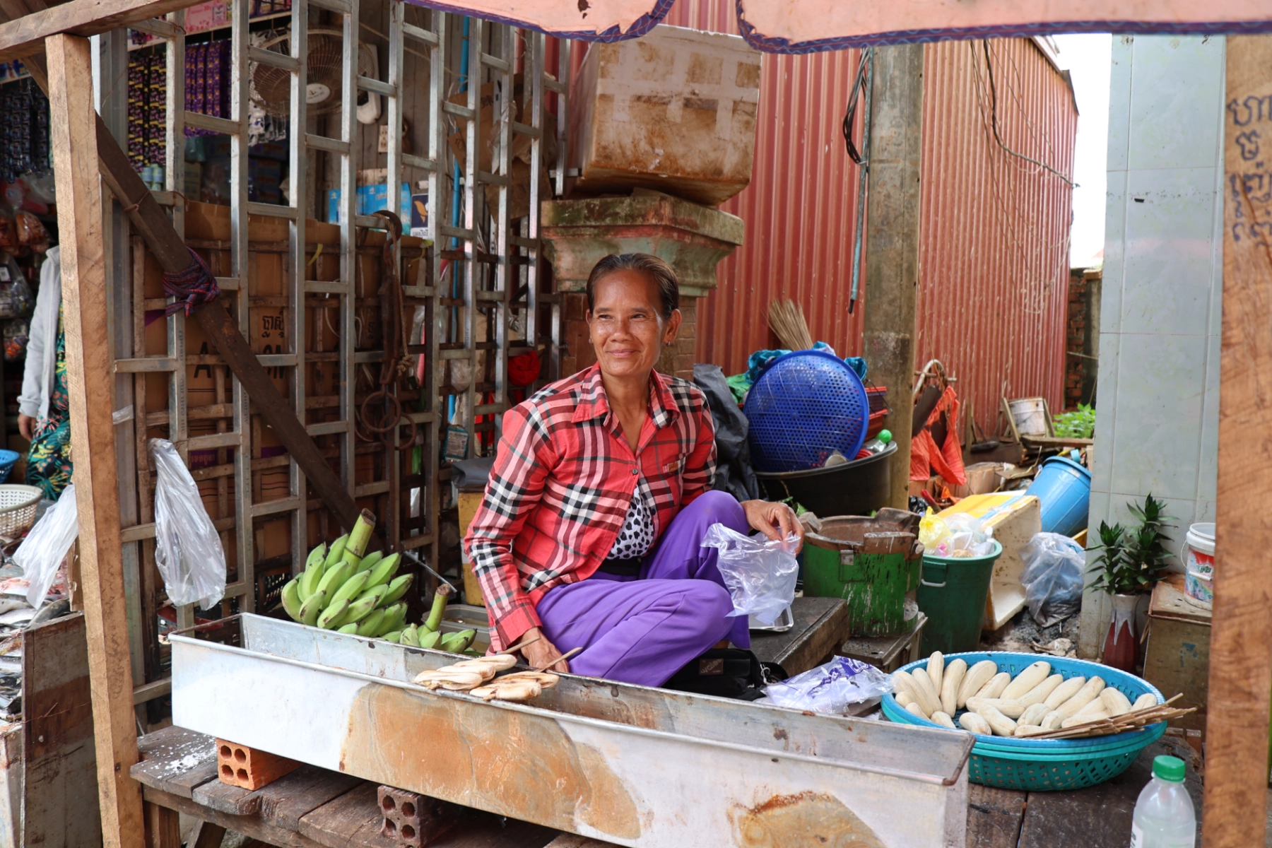 Elderly woman selling grilled banana in Mondulkiri, Cambodia