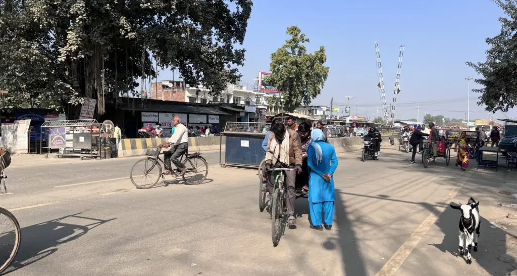 A woman questions two people on a rickshaw while they are attempting to cross the Nepalgunj border, as part of her job description to monitor cross-border trafficking cases.