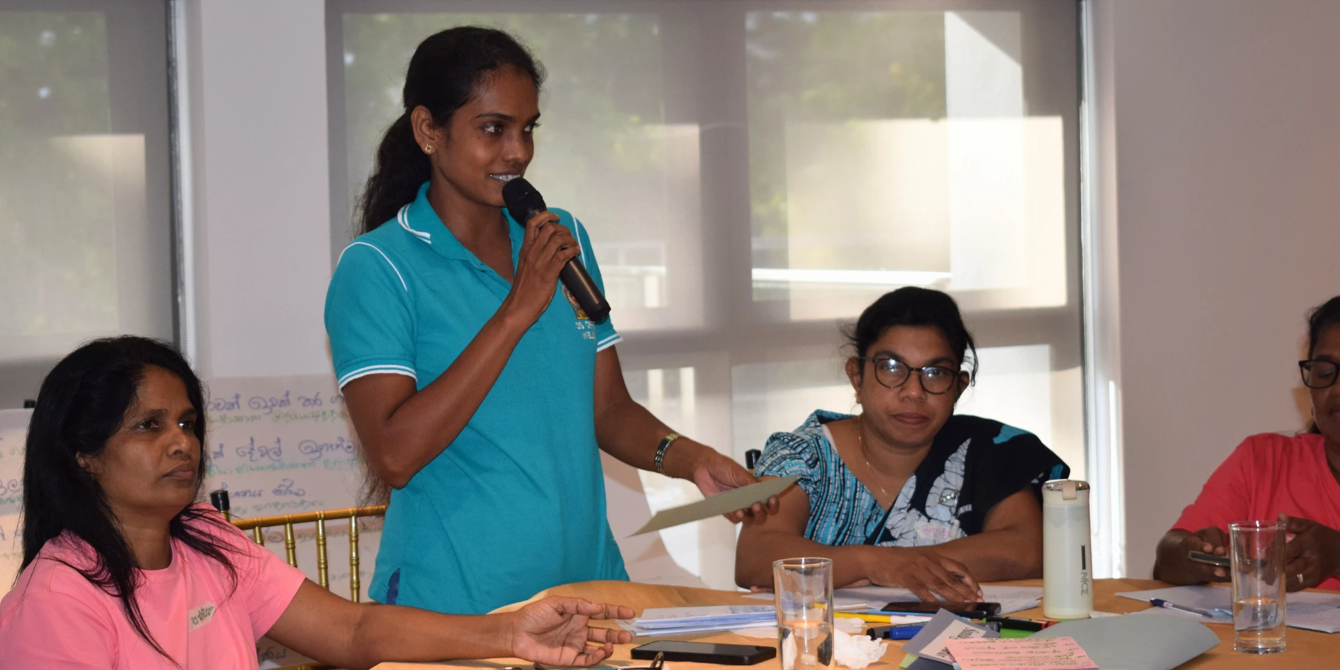A participant sharing feedback at a Training of Trainers program on women's leadership for Community Women's Collectives.